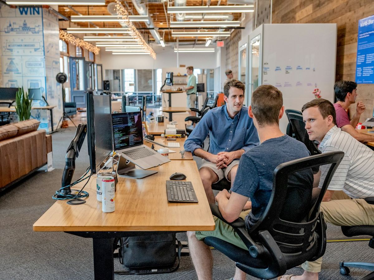 Recruiters and engineers in discussion at an office desk