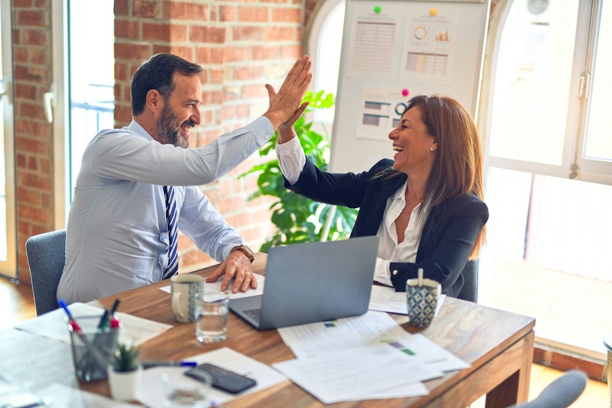 Hiring manager and candidate celebrating a successful offer